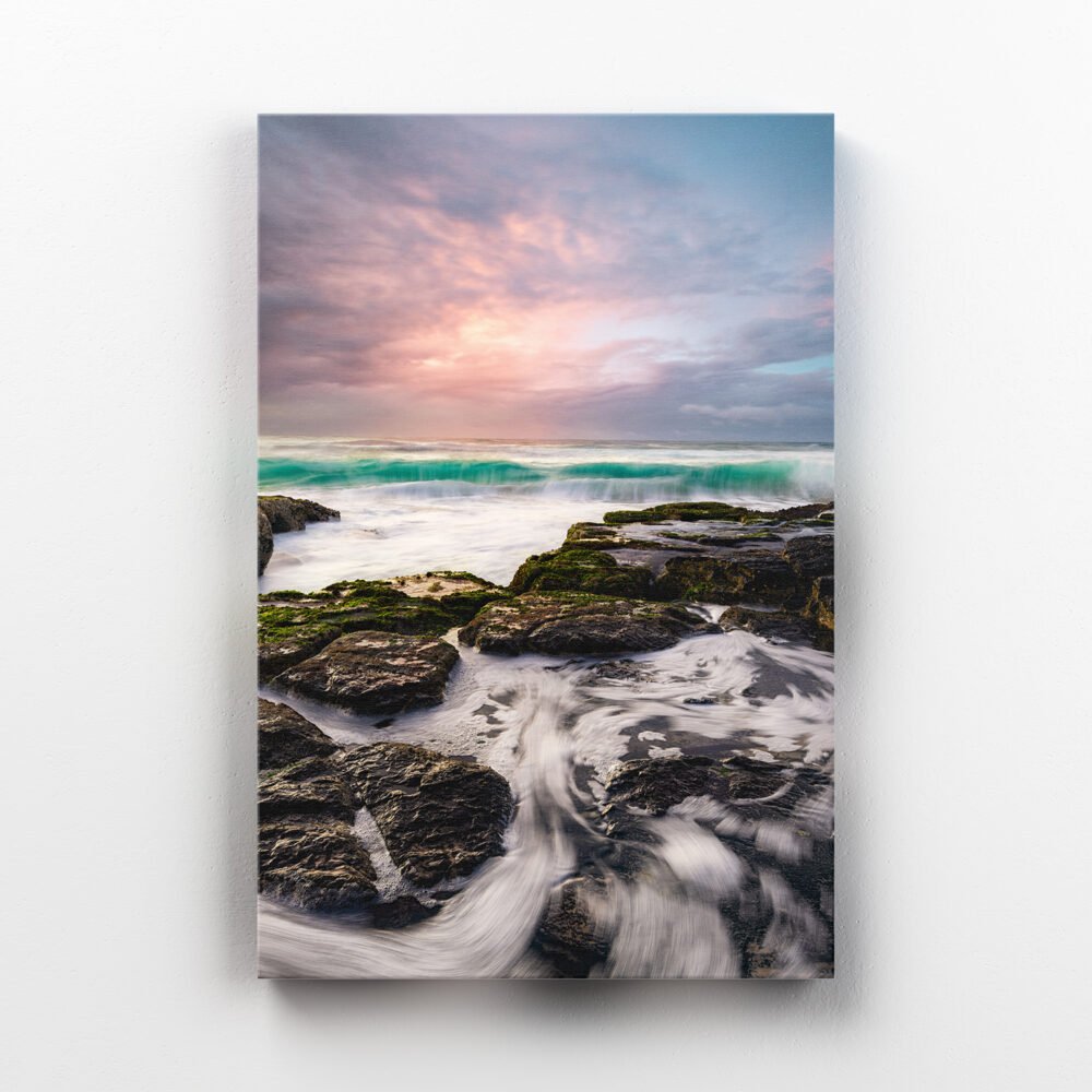 Canvas print of a turquoise wave approaching the rocks at Shelly Beach, Ballina